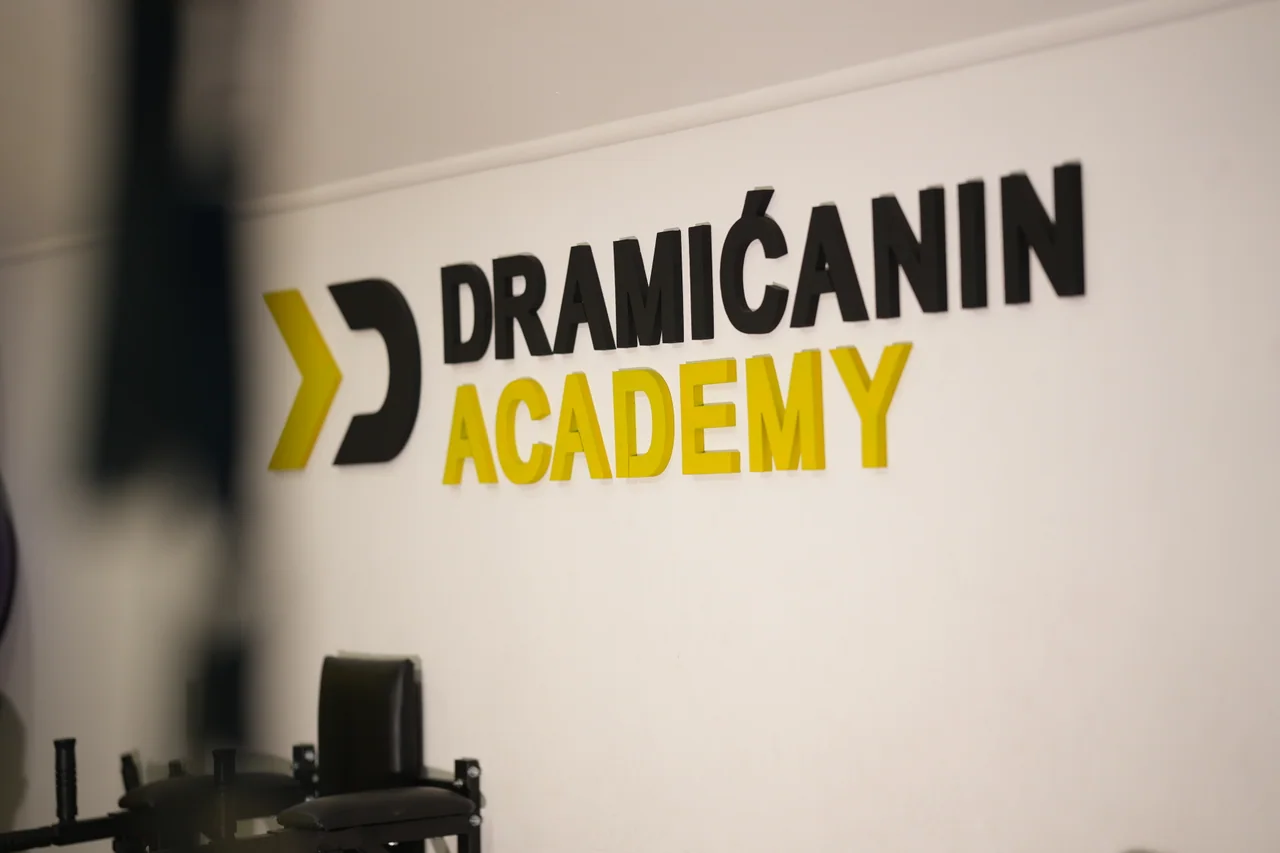 The Dramićanin Academy logo inside the training space.
