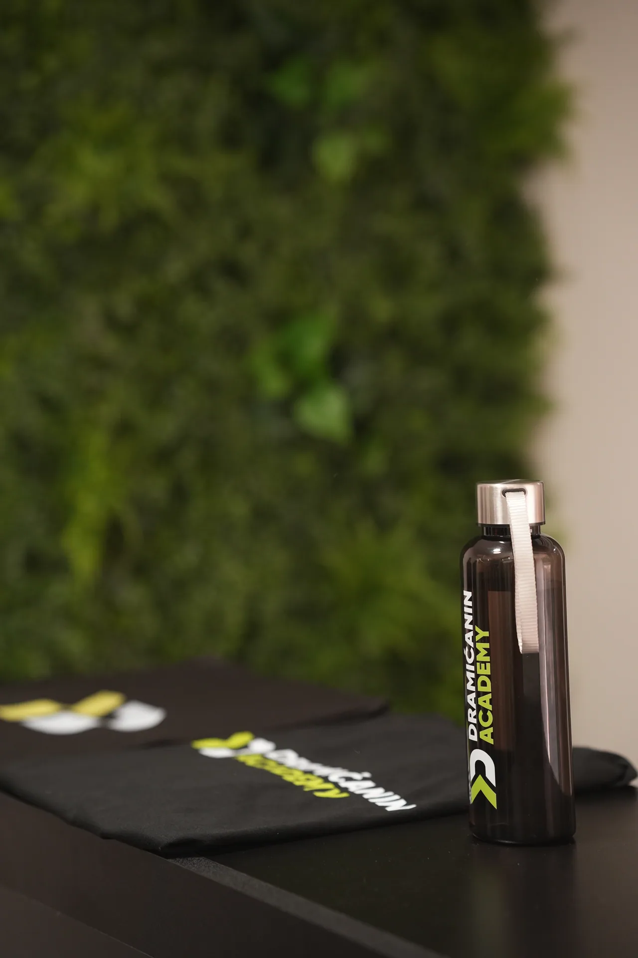 A branded Dramićanin Academy bottle and training gear.